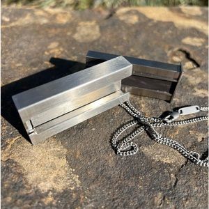 Necklace with stainless steel charm that serves as matchbox